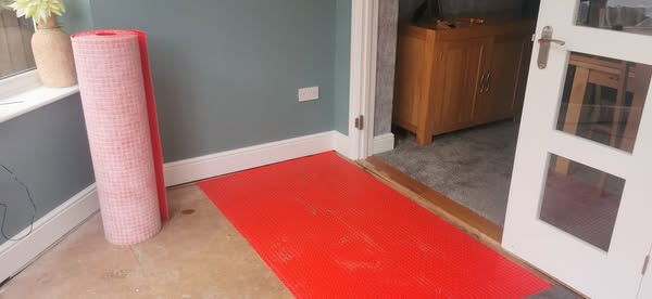 "ready for the First row of floor tiles to be installed as part of the tiling job in Basildon, Essex."