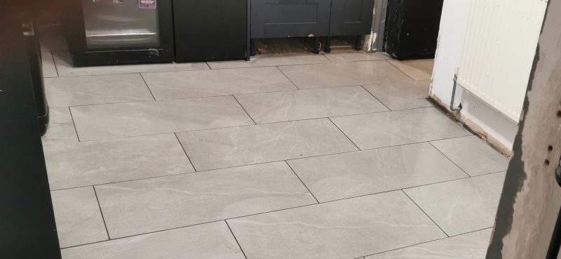 "Recently completed grouting and cleaning of a tiled floor in a home in Basildon, Essex, showcasing a pristine, smooth finish."